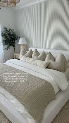 a large bed sitting in a bedroom next to a lamp and window with blinds on it