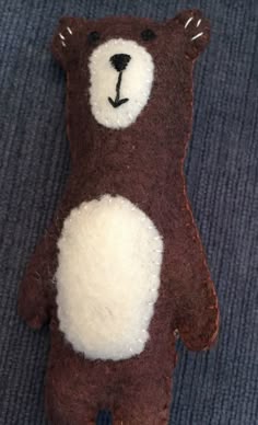 a brown and white teddy bear laying on the ground