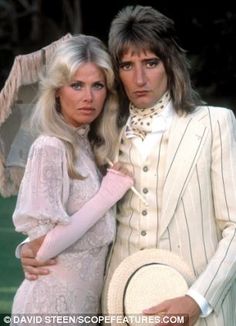 two people dressed in white posing for a photo