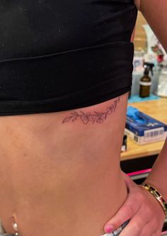 a woman with a tattoo on her stomach