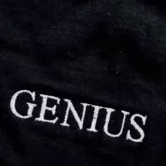 the word genius written in white on a black shirt