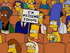 a group of people sitting in the middle of a room with signs that say i'm missing school