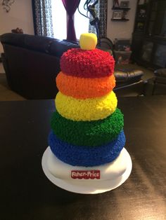 a cake made to look like a stack of rainbows
