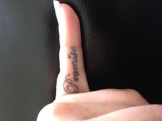 a person with a small tattoo on their finger pointing to the word pomzie