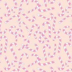 pink and white candy canes on a light pink background seamless wallpaper pattern