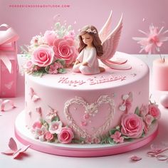 a pink birthday cake decorated with flowers and angel figurines