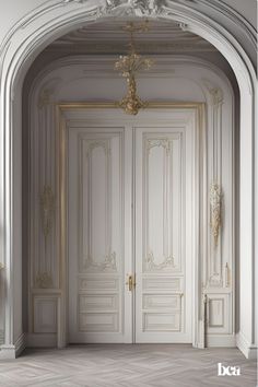 an empty room with two doors and a chandelier
