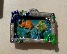 there is a small metal frame with some fish in it