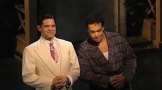 two men in suits standing next to each other
