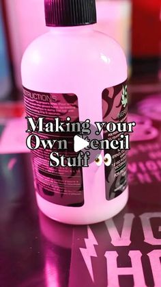 a bottle of pink stuff sitting on top of a table