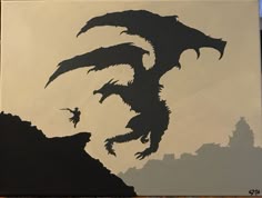 the silhouette of a dragon is painted on a canvas