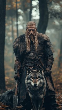 a man with long hair and beard standing in the woods next to a wolf,