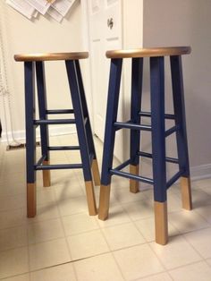 two wooden stools sitting next to each other