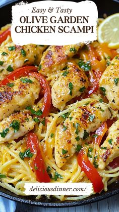 an image of chicken and pasta in a skillet with lemon wedges on the side