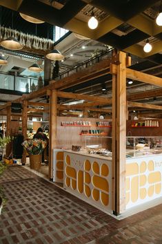 the inside of a food stand with lights hanging from the ceiling