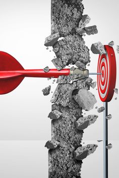 a red dart hitting in the center of a wall with rocks and debris surrounding it
