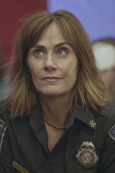 a woman in uniform looking at the camera