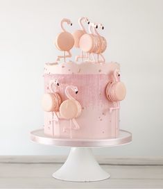 a pink cake with flamingos on top is featured in the instagram page for this post