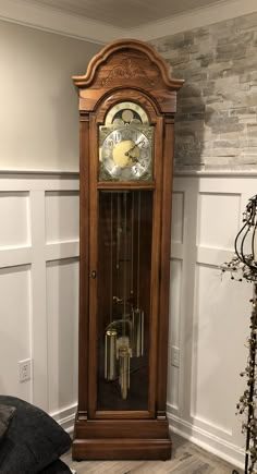 an old grandfather clock in the corner of a room