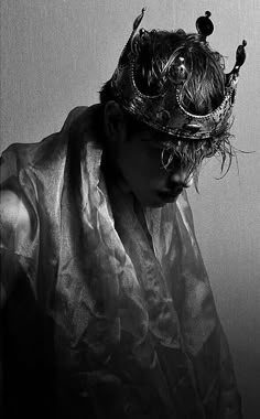 black and white photograph of a woman wearing a crown with her hair blowing in the wind