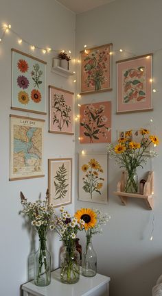 there are many flowers in vases on the wall