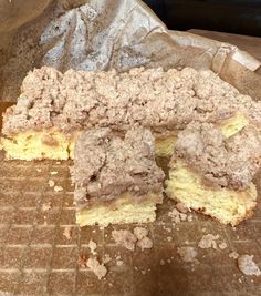 a piece of cake sitting on top of a table covered in powdered sugar and crumbs