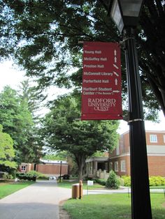 a red sign hanging from the side of a metal pole