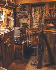 an old fashioned kitchen with wooden floors and walls