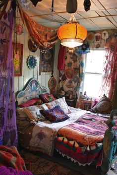 a bed room with a neatly made bed and lots of decorations on the wall above it
