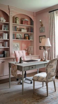 a desk and chair in a room with pink walls
