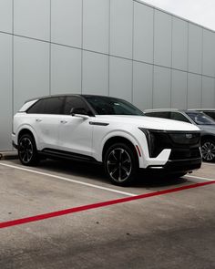 two white suvs are parked next to each other