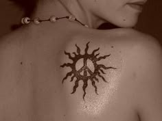 a woman with a sun tattoo on her back