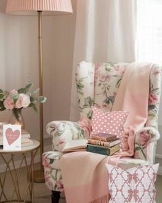 a living room filled with furniture and flowers on the floor next to a lamp, window