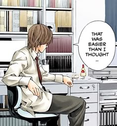 a man sitting at a desk in front of a book shelf