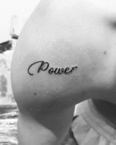 a woman's lower arm with the word power tattooed on her left side ribcage