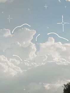 the sky is filled with white clouds and small stars in the middle of it's image