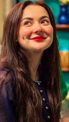 a close up of a person with long hair and a smile on their face,