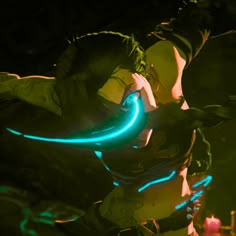 a man with green hair holding a blue neon light