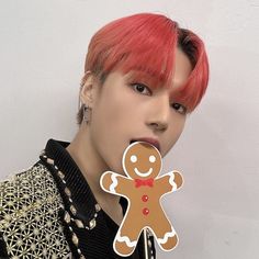 a person with red hair holding up a cut out of a ginger man