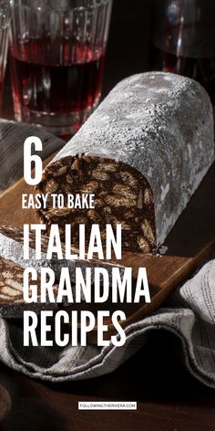 a loaf of bread sitting on top of a wooden cutting board next to glasses of wine