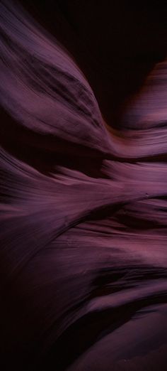 an abstract image of purple and red rocks in the desert with water flowing down them