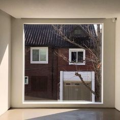 an empty room with a large window looking out onto the street