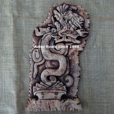 an intricately carved piece of wood on a gray background with the words, arts roots since