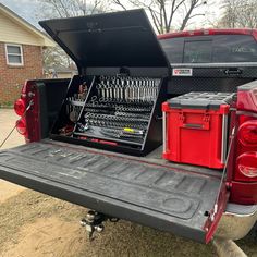 the back end of a pickup truck with tools in it's cargo trays
