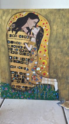 a painting on the wall of a building with a woman holding a baby in her arms