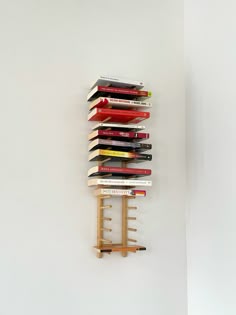 several books are stacked on top of each other in the shape of a book rack