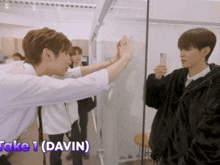 two young men giving each other a high five with the words take 1 davin below them