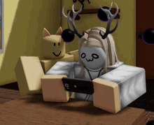 a girl with antlers is sitting on a table looking at her phone