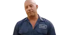 a man wearing a blue shirt with a patch that says toretto on it