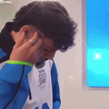 a man wearing a vest that says visa on the front